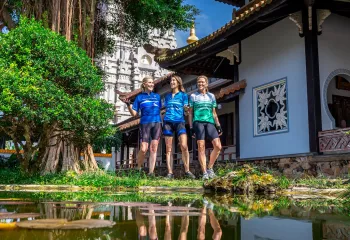 Three Women in Backroads Jerseys walk through a temple