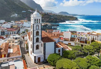 Town full of white and brown buildings with a church bell tower in the center