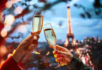 Two hands holding up glasses of champagne