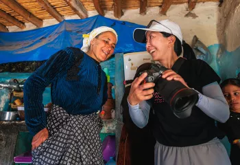 Woman showing another woman a photo on a camera