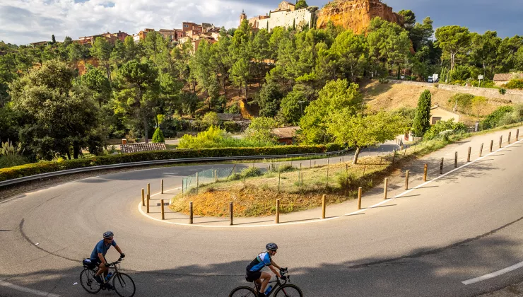 Guests cycling towards hilltop castle. 