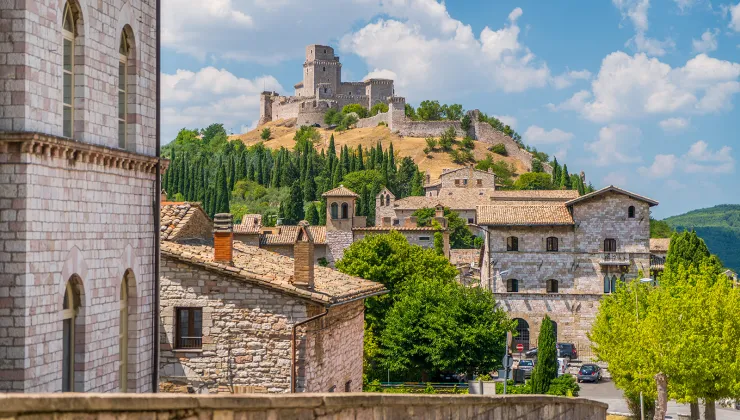 Wide shot of brick villages, large brick building on hilltop.