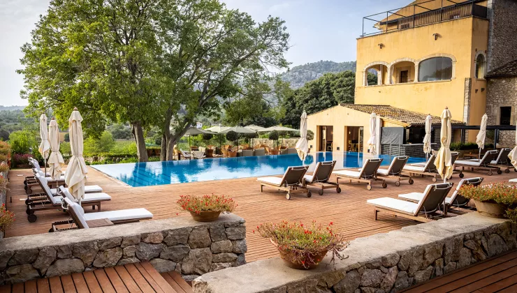 pool and lounge chairs outside of hotel
