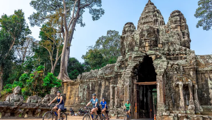 people bike through a covered bridge