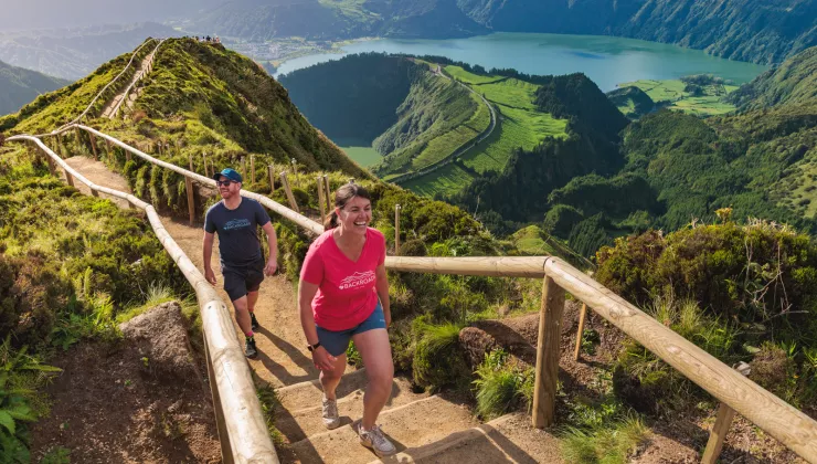 Man and woman walking up stairs on a path on a hill