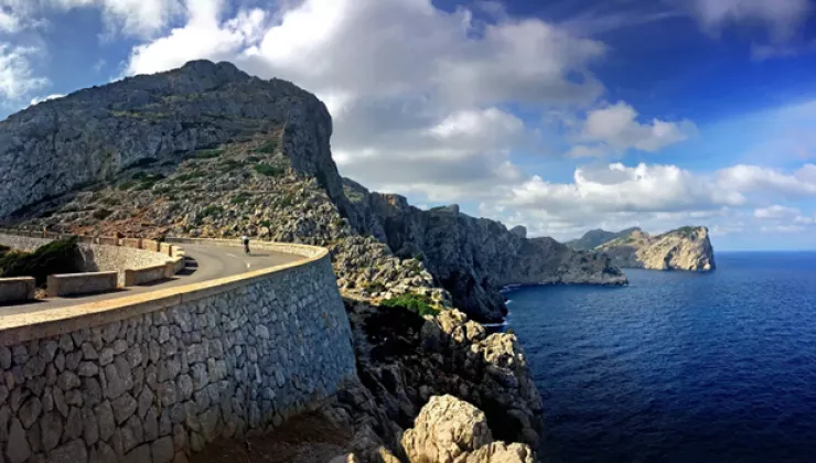 Windy road with a cliff and ocean in the background
