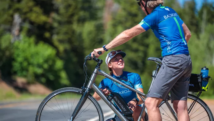 Woman checking on man's electric bike