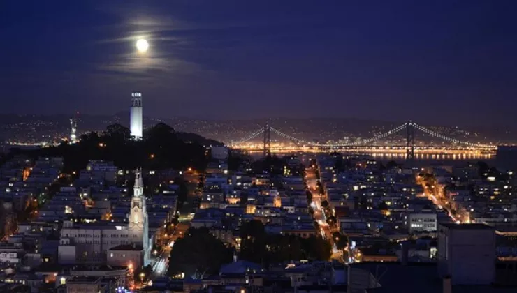 Evening, city view of San Francisco with houses illuminated by lights