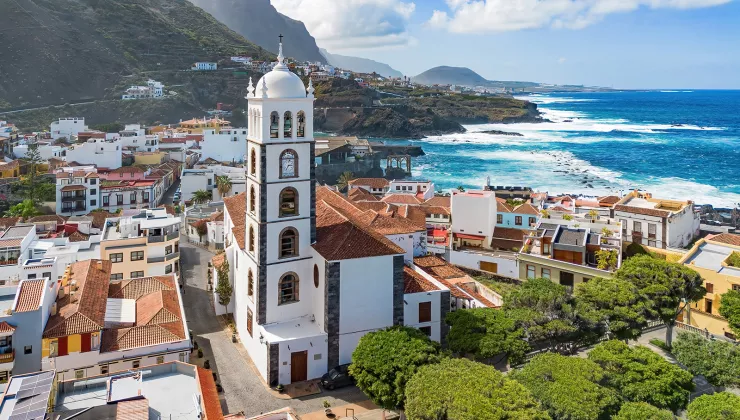 Town full of white and brown buildings with a church bell tower in the center