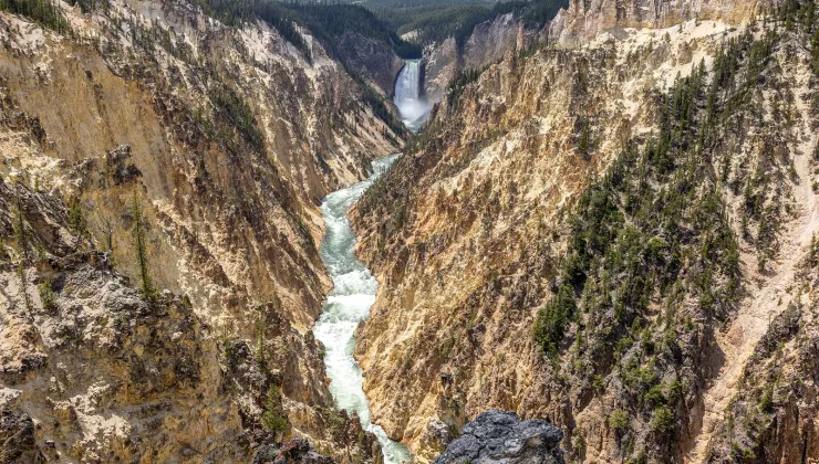 Active river cutting through two large mountains