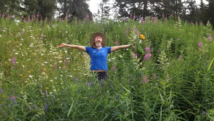 Backroads trip leader with wildflowers in Alaska