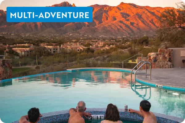 Group of people in a hot tub, looking out to a large lake