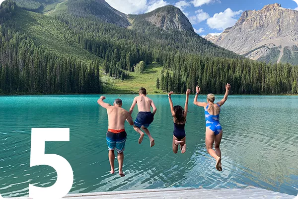 family jumping in Canadian Lake
