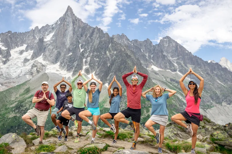 Group of Backroads hikers doing a yoga pose in the Alps