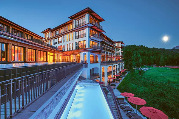 large hotel with swimming pool and greenspace