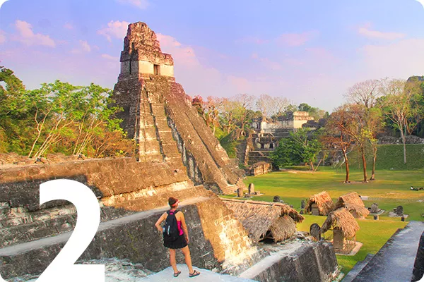 text:2; image: Woman standing in front of a stone ruin