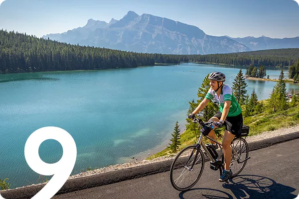 text:9: image: person riding a bike next to a waterway