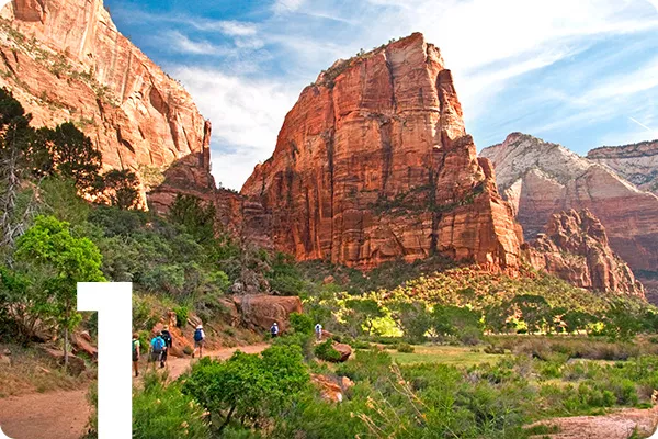 text:1;image: a group of hikers approach tall rock formations