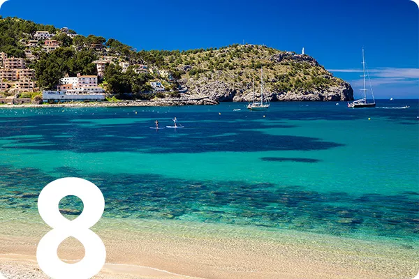 text:8; image: Beach with clear blue water and an island in the distance