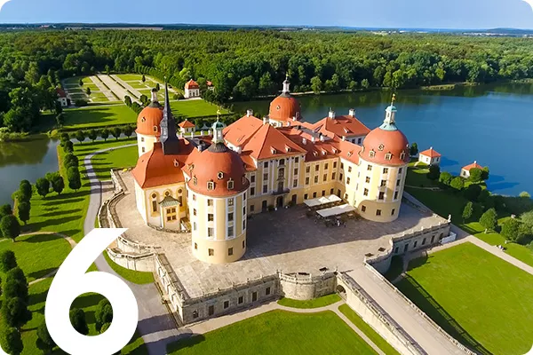text: 6; image: Castle surrounded by lawns and blue lake