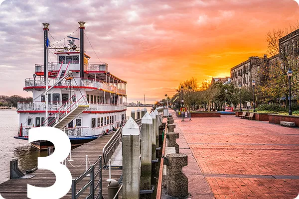 text:3 ; image: Pier with a ship next to it and a sunset in the background