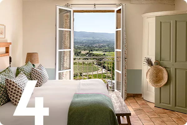 text:4; image: hotel bedroom with French doors overlooking a vineyard
