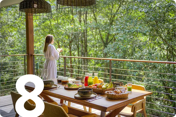 text:8; image: woman stands on balcony with a big table on it