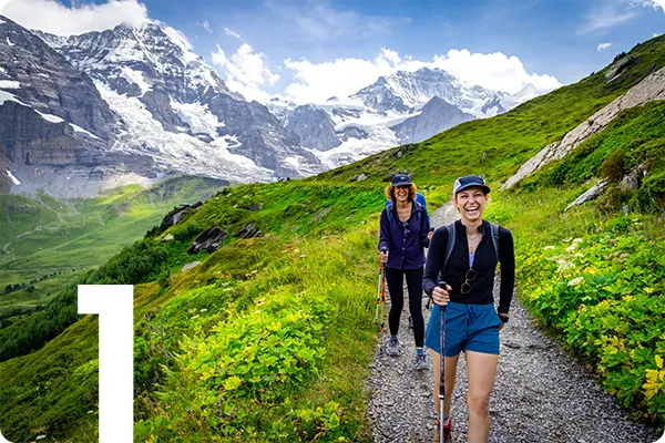 text:1; image: two hikers on a grassy path