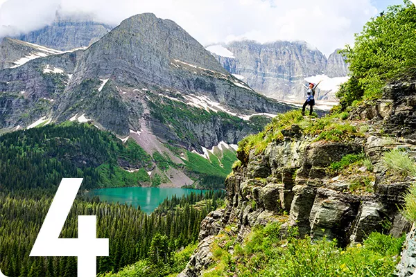 text:4; image: hiker on top of mountain surrounded by grass and mountains