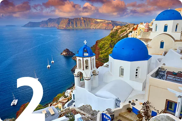 text:2; image: A blue domed building overlooking the ocean