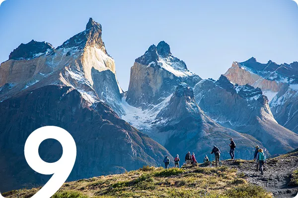 text:9; image: Hikers stop to admire mountain range