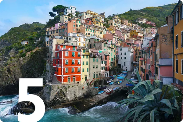 text:5; image: colorful buildings built into a riverside