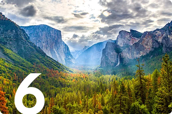 text:6; image: colorful trees in front of a mountain range