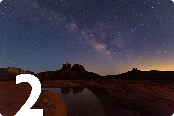 text:2; image: stars in the nightsky over a canyon