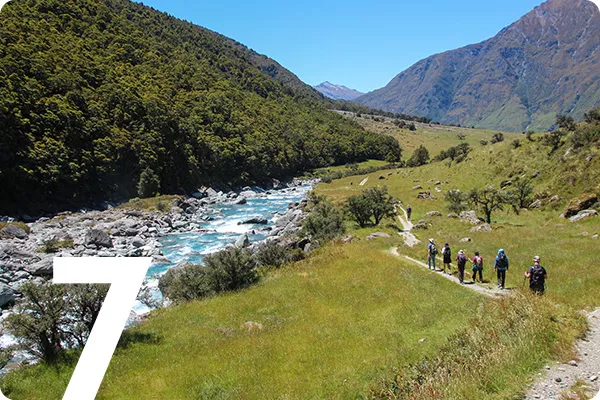 Hikers walking by a creek