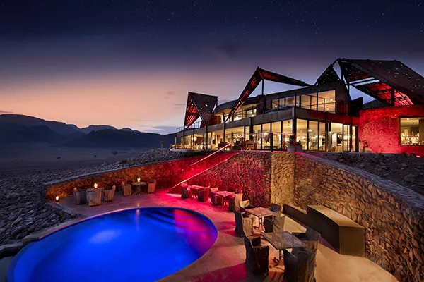 Hotel and pool lit up at night