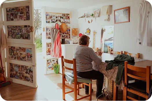 Woman sitting at a table in a decorated room