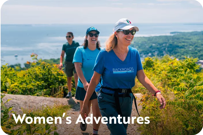 Group of women hiking on a dirt trail