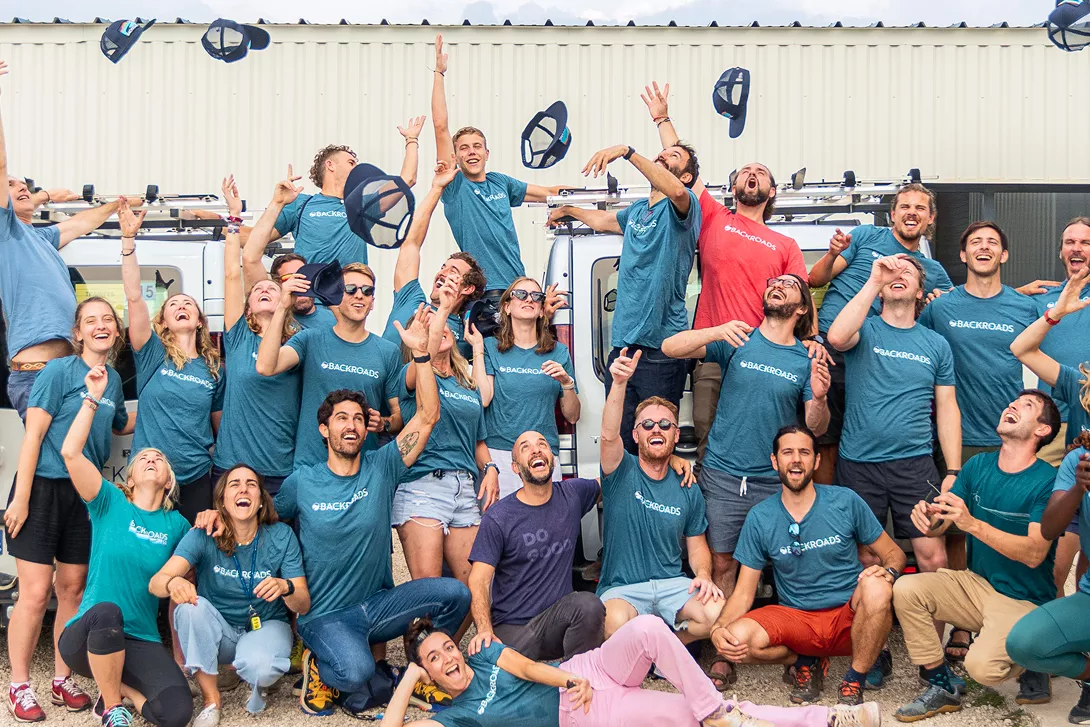 Group of people smiling while throwing hats in the sky
