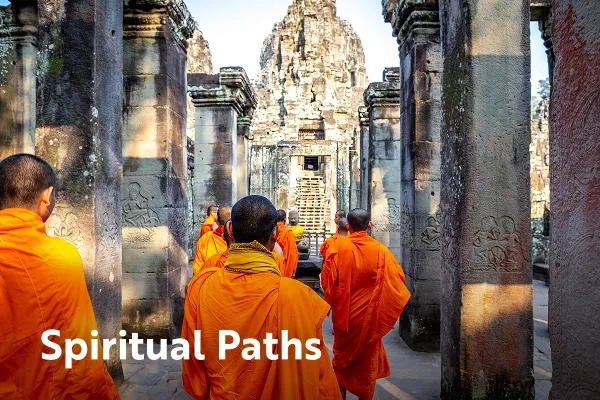 Monks in orange clothes enter a large stone temple with text overlay "spiritual paths"