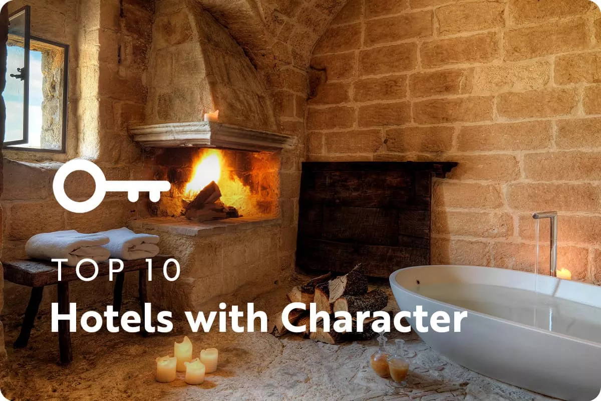 text: top 10 hotels with character; image: bathtub with brick walls