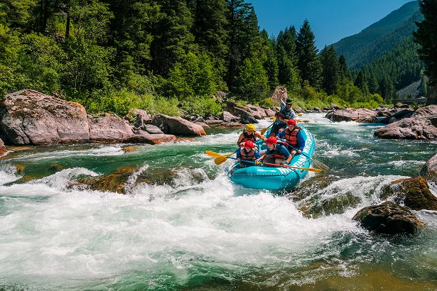 Group of people rafting in an active river