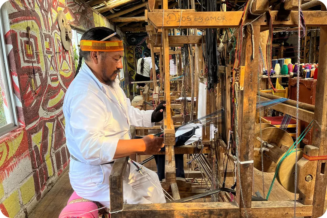 man weaving on a loom