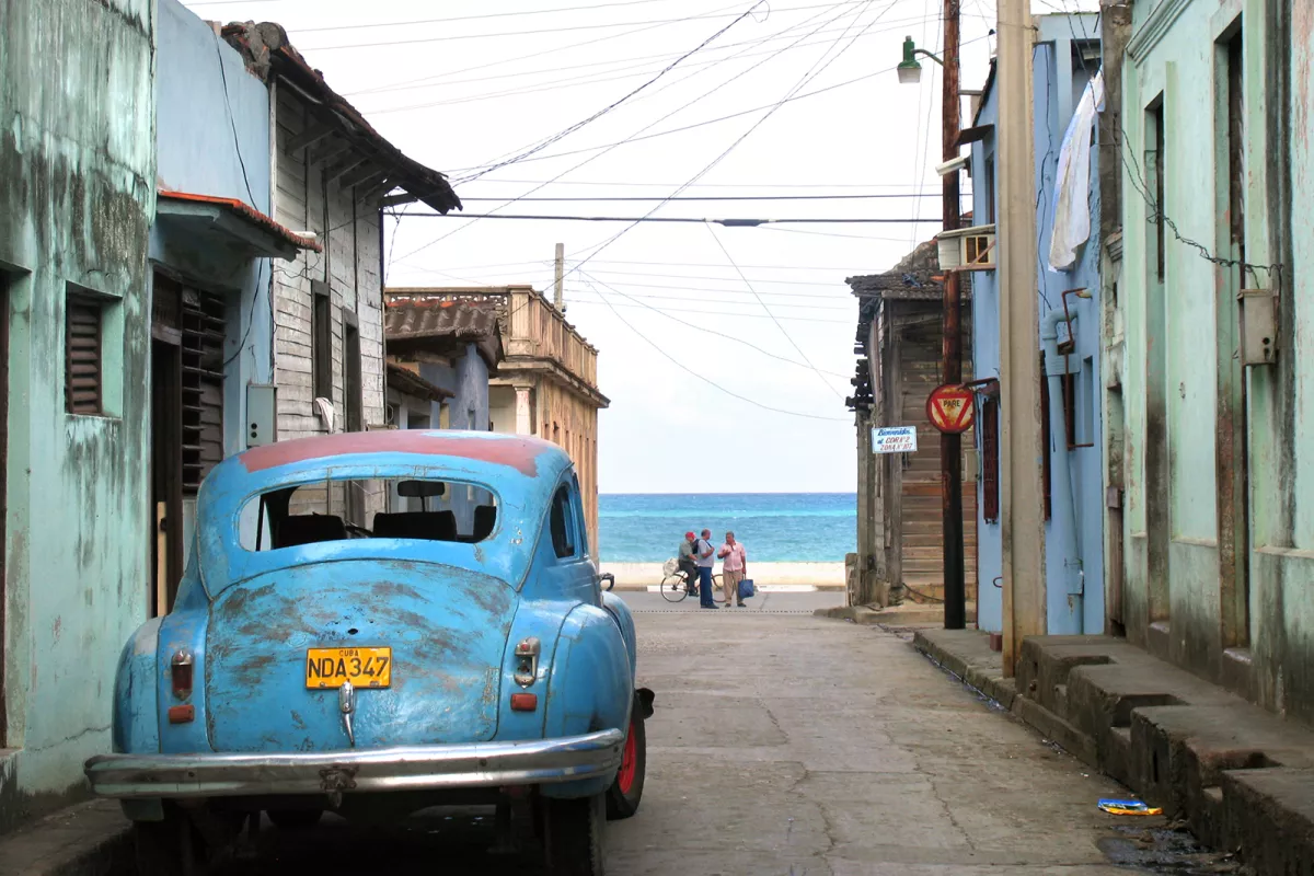 Blue car in front of homes
