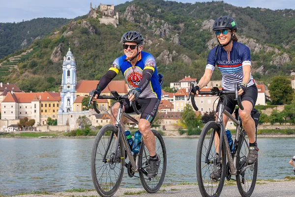 Two bikers riding along the Danube river