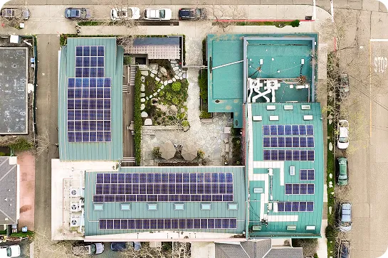 Top-down view of a green office building with solar panels on the roof