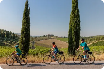 Three family members biking in the middle of a valley