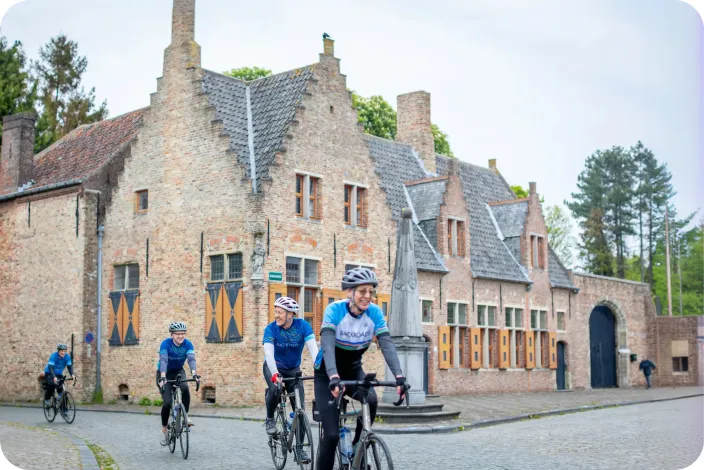 Group of people biking in front of European-style buildings