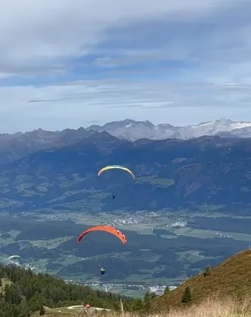Parachutes over a mountain range
