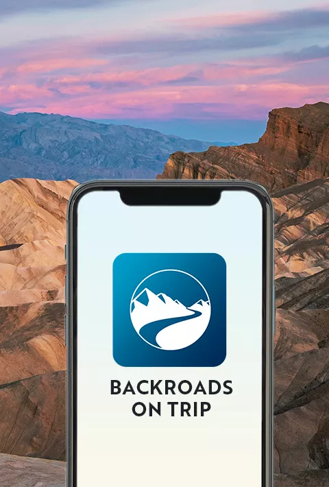 Phone showing the Backroads logo over a desert at sunset